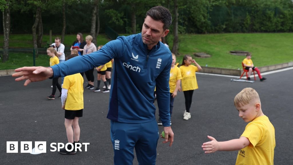 James Anderson runs a youngster through a bowling drill at an event for Chance to Shine
