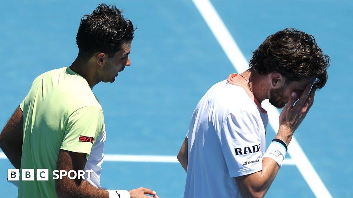 Cameron Norrie holds his hand to his face after losing in Auckland