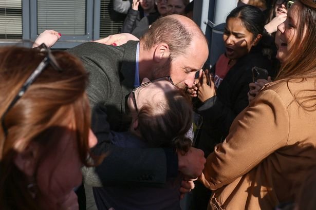 Prince William hugs starstruck fan as he's mobbed by screaming students