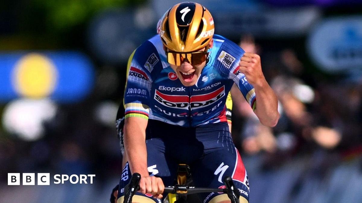 Remco Evenepoel punching the air with delight as he crosses the finish line