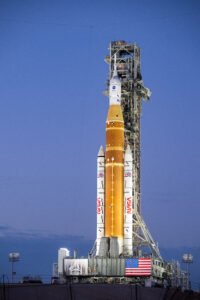 NASA's orange and white Space Launch System rocket on the launch pad.