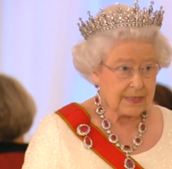 Queen Elizabeth II wearing a diamond tiara and a ruby and diamond necklace and brooch