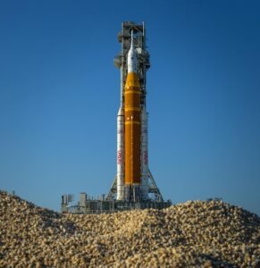 NASA’s Artemis II Space Launch System (SLS) rocket and Orion spacecraft are seen atop a mobile launcher at Launch Complex 39B, Friday, March 27, 2026, at NASA’s Kennedy Space Center in Florida. NASA’s Artemis II test flight will take Commander Reid Wiseman, Pilot Victor Glover, and Mission Specialist Christina Koch from NASA, and Mission Specialist Jeremy Hansen from the CSA (Canadian Space Agency), around the Moon and back to Earth with launch opportunities beginning in April 2026. Photo Credit: (NASA/Bill Ingalls)