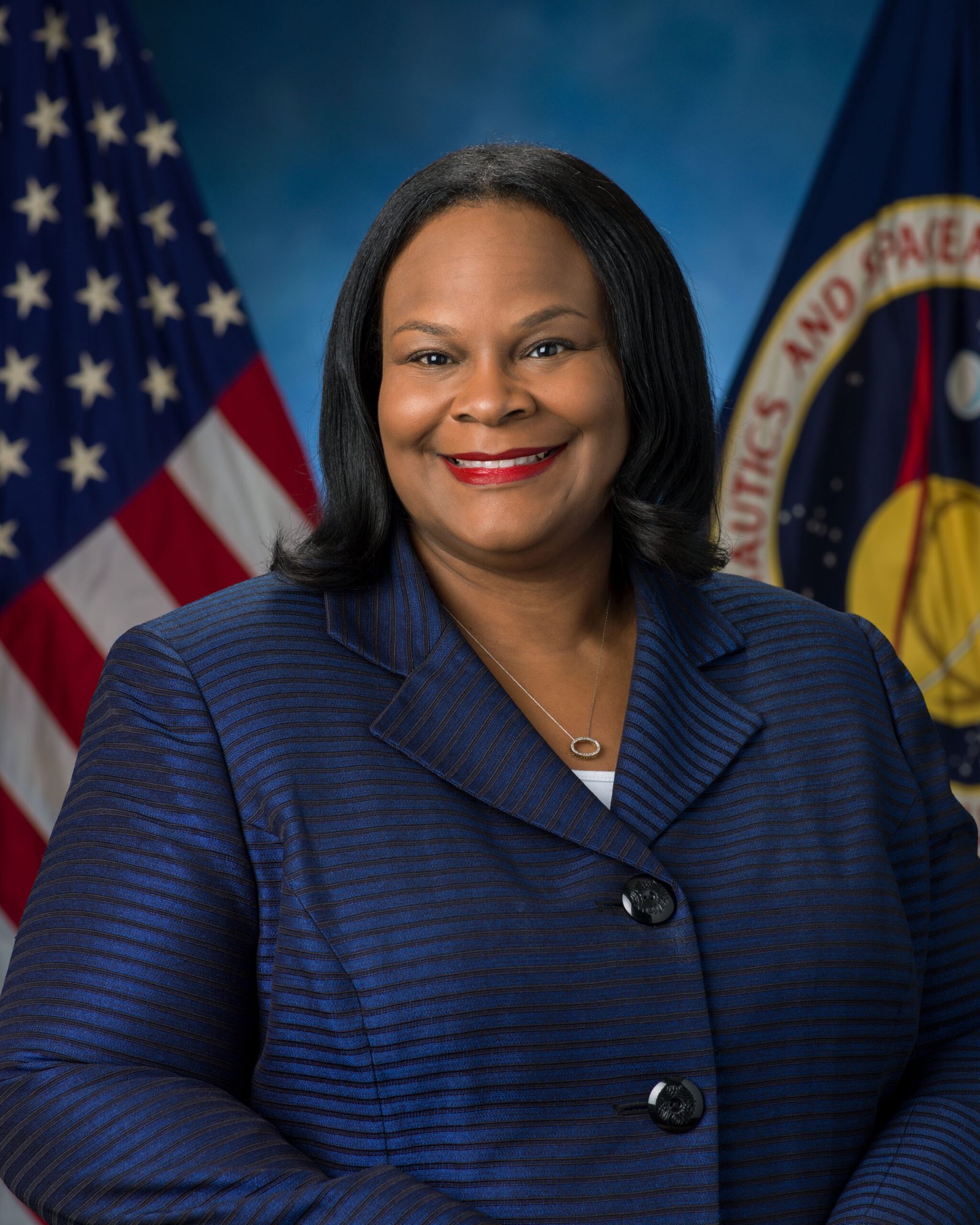 Portrait of Dawn L. Oliver, with U.S. and NASA Flags in background.