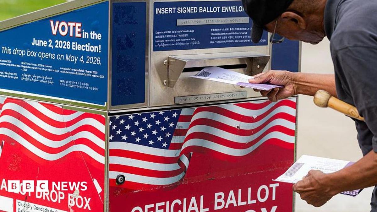 A man dropping a ballot in the mail box