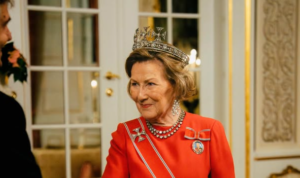 Queen Sonja wears a tiara with three crosses on the top