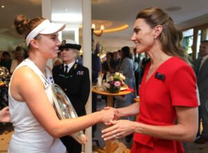 Linda Noskova is presented with the Wimbleson trophy by the Princess of Wales