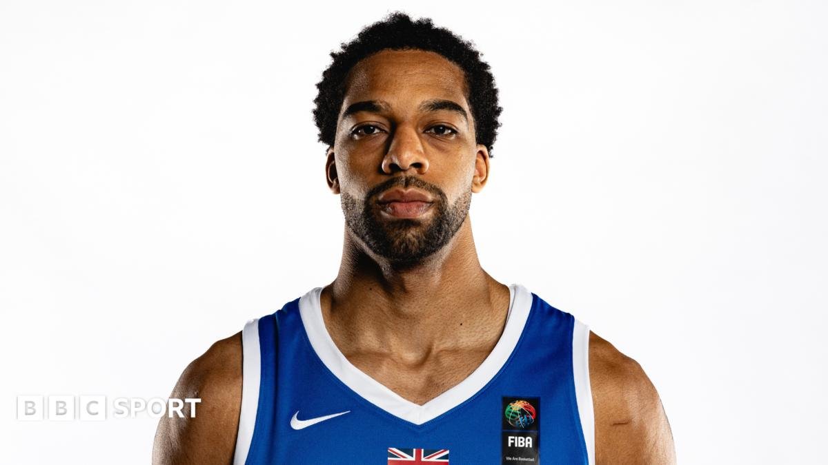 Tosan Evbuomwan poses for a portrait shot wearing a Team GB basketball vest