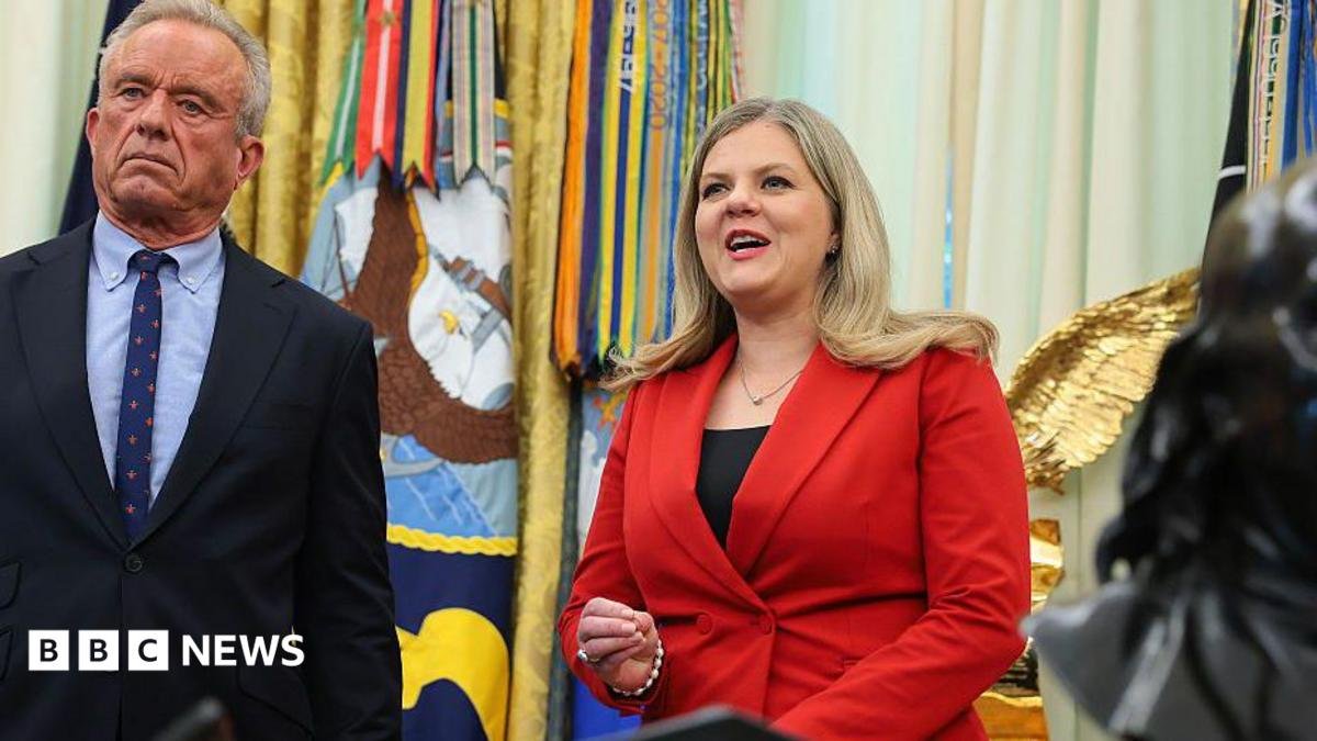 Heidi Overton, wearing red, speaking in the Oval Office beside health secretary Kennedy