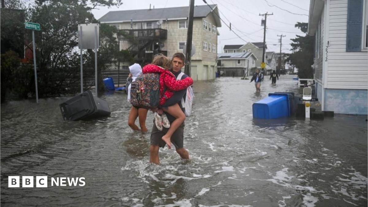 People walk in flooded streets in Surf City, New Jersey, on 26 September 2026