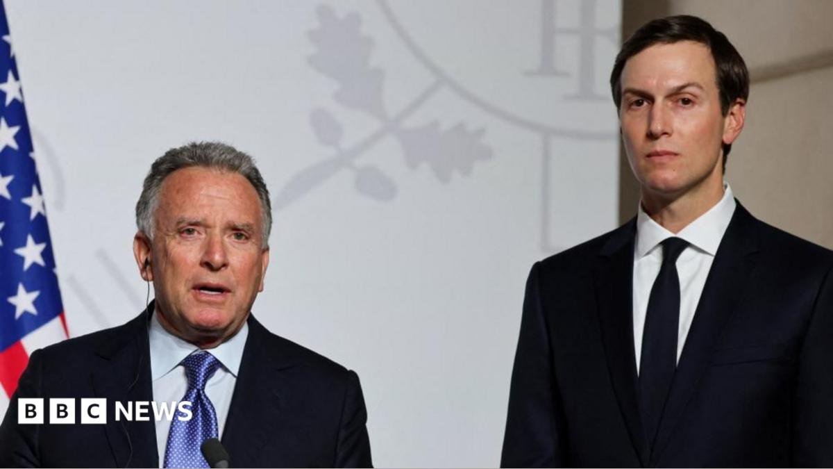 Steve Witkoff (left) and Jared Kushner (right) stand side by side looking directly towards the camera. They are both in black suits with white shirts. Witkoff has a blue patterned tie and Kushner has a black tie