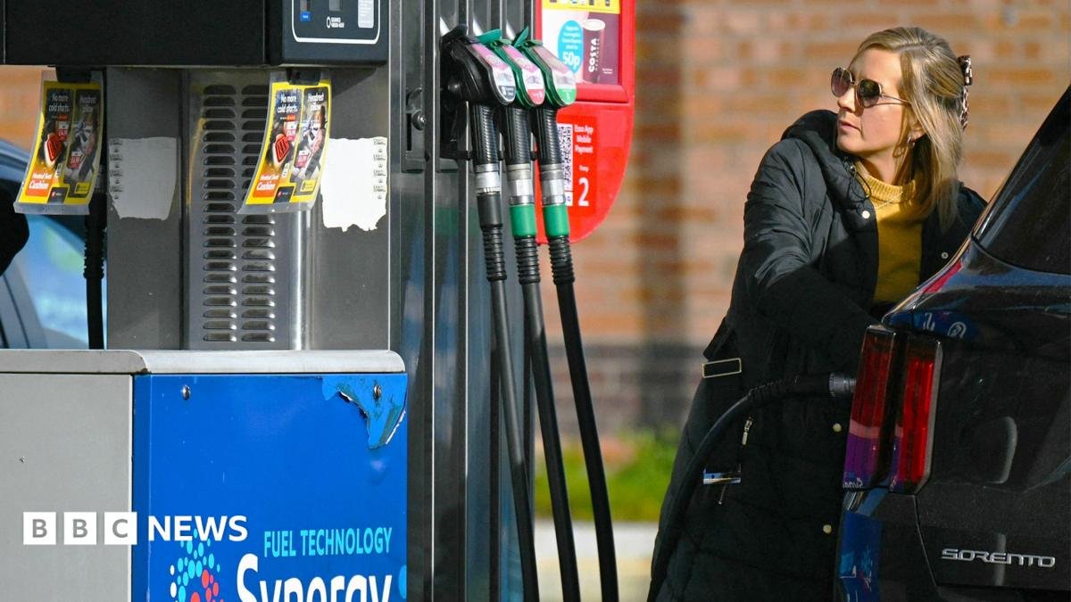 A woman fills up her car with petrol