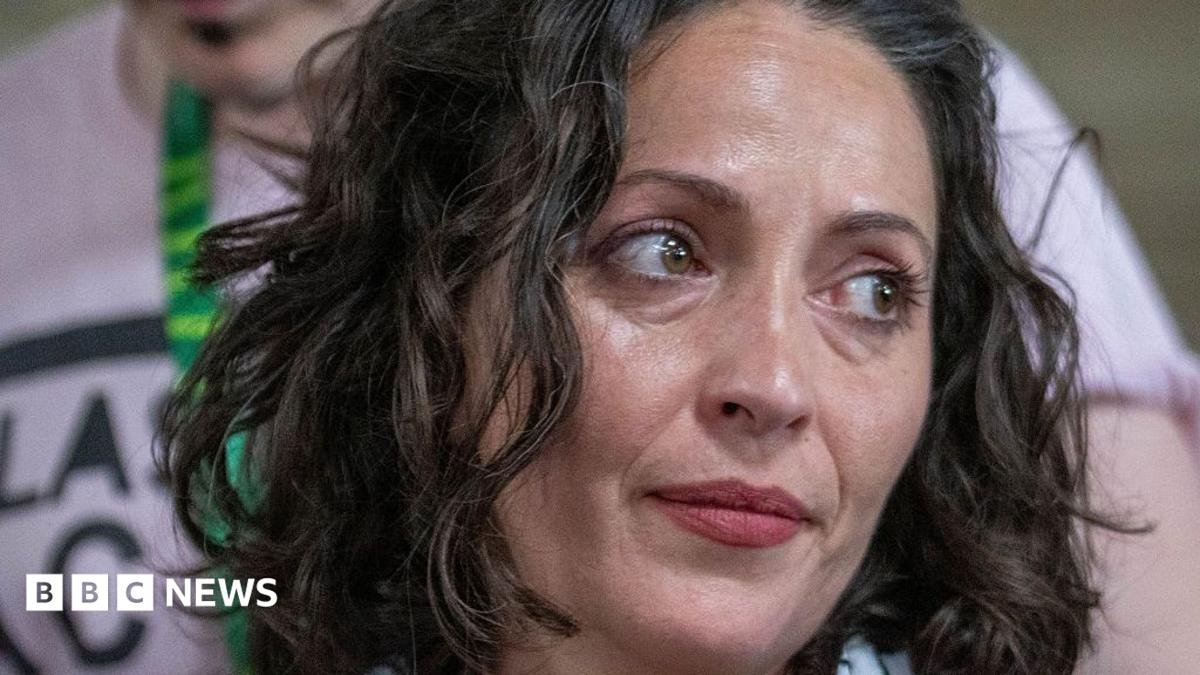 A close up image of Lubna Speitan looking to her side.